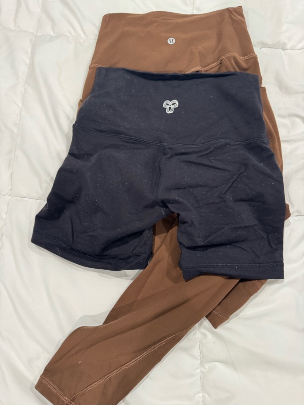Aritzia Black Bike Shorts Layered Over Brown Leggings